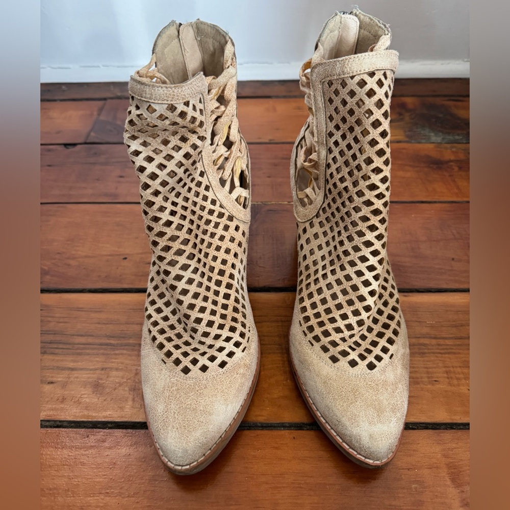 Heeled booties in size 10 with funky cut out details.